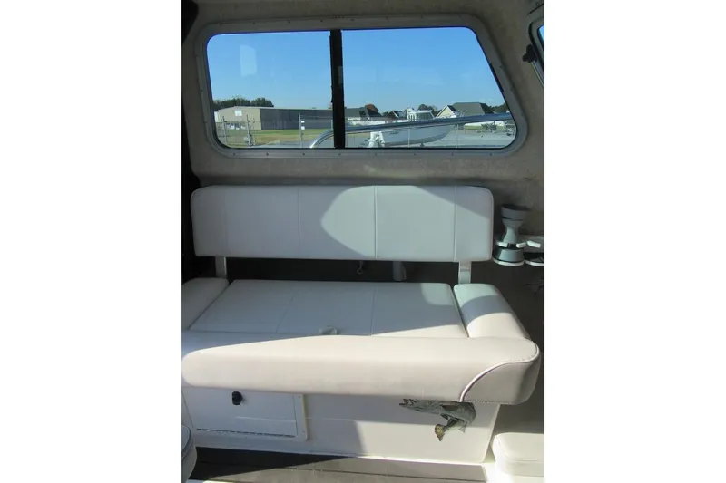 Slide: The Image of 2024 Parker 2320 SL Sport Cabin interior with white seating and window view. - 21