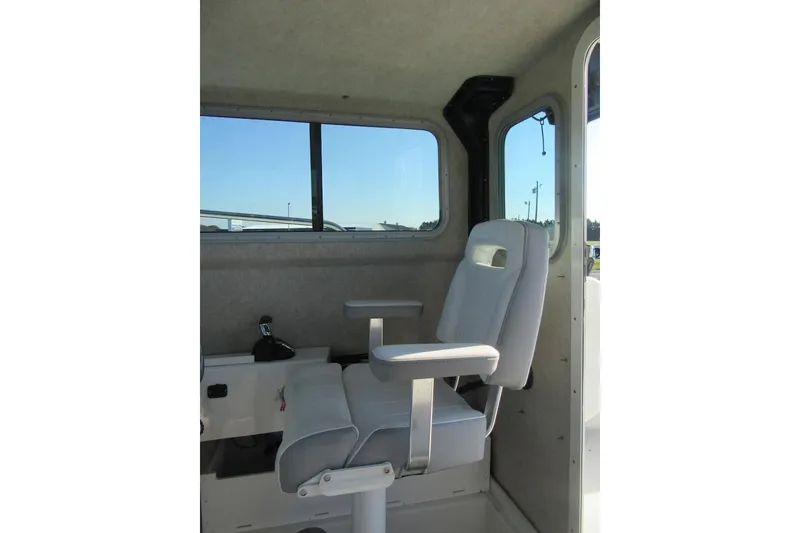 Slide: The Image of 2024 Parker 2320 SL Sport Cabin interior with captain's chair and window view. - 24
