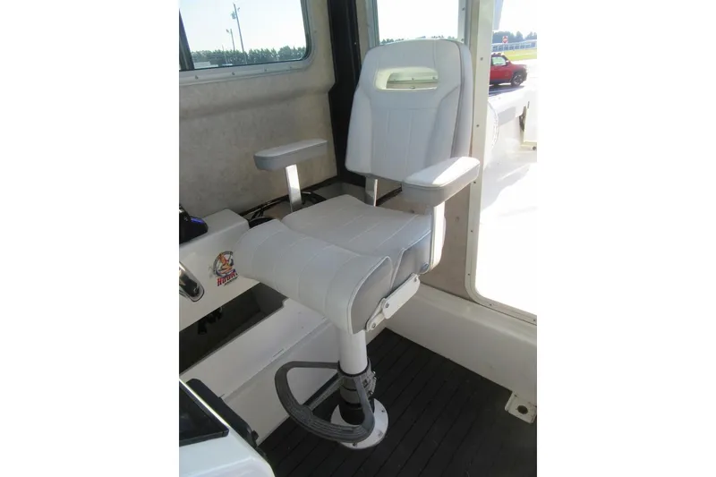 Slide: The Image of Captain's chair in 2024 Parker 2320 SL Sport Cabin boat interior. - 29