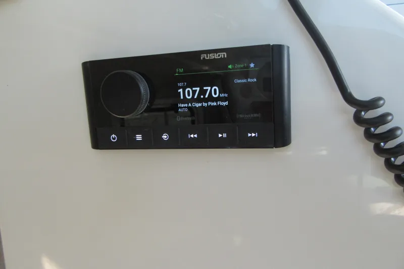 Slide: The Image of Fusion marine stereo on 2024 Parker 2320 SL Sport Cabin, displaying FM 107.7 MHz. - 33