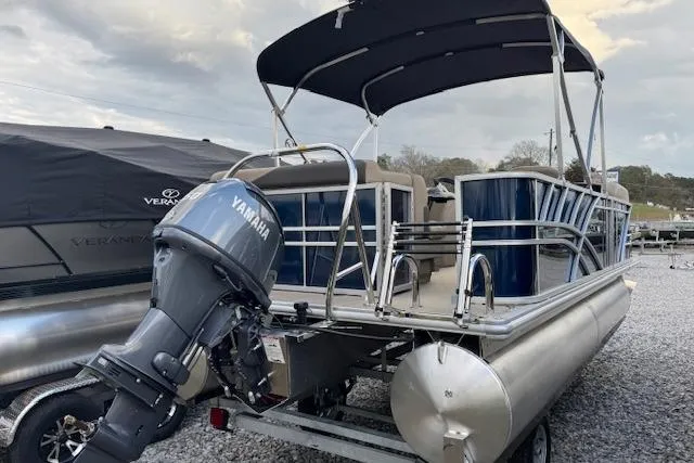 Slide: The Image of 2026 Sylvan Mirage 820 CRS pontoon boat with Yamaha outboard motor, parked on gravel. - 10