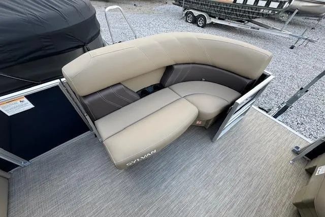 Slide: The Image of 2026 Sylvan Mirage 820 CRS boat interior with beige seating and carpeted flooring. - 12