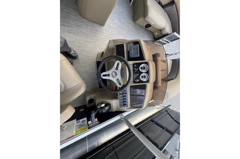 Slide: The Image of 2026 Sylvan Mirage 820 CRS boat dashboard with steering wheel and controls. - 6