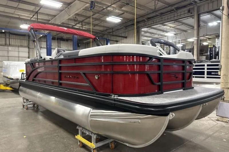 Slide: The Image of 2026 Bennington 22 SSRSF pontoon boat with red exterior in a warehouse setting. - 4