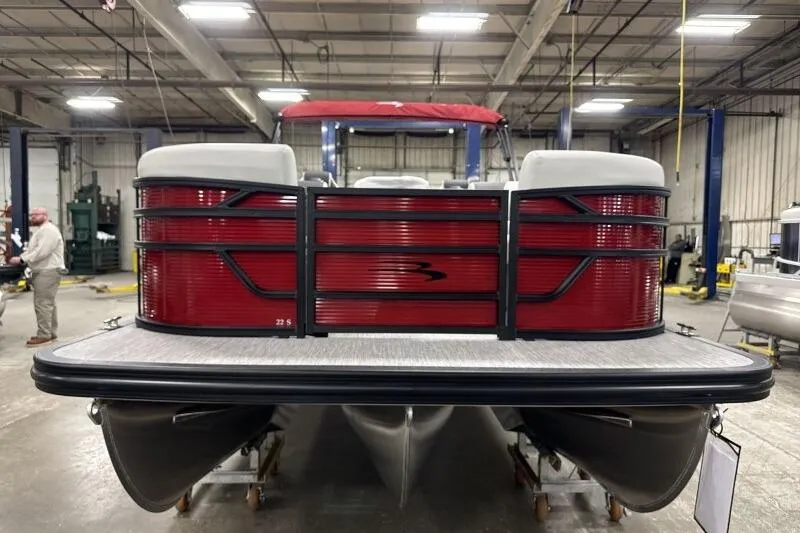 Slide: The Image of 2026 Bennington 22 SSRSF pontoon boat in a warehouse setting. - 5