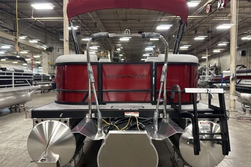 Slide: The Image of 2026 Bennington 22 SSRSF pontoon boat in a showroom, rear view with red accents. - 8