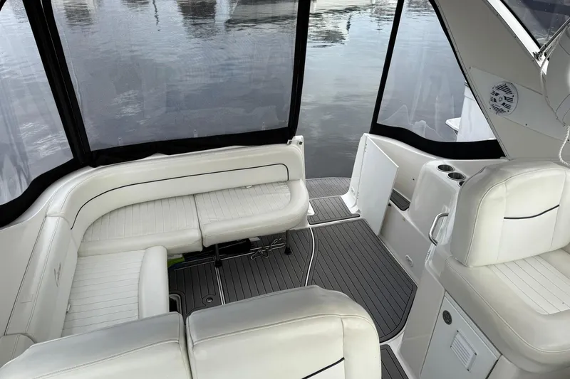 Slide: The Image of Interior of 2000 Bayliner 3055 Ciera Sunbridge DX/LX with white seating and water view. - 11