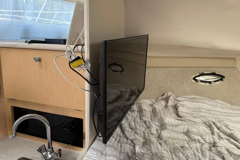 Slide: The Image of 2000 Bayliner 3055 Ciera Sunbridge DX/LX interior with TV, bed, and porthole. - 17