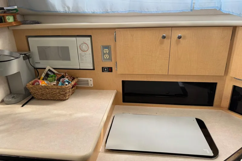 Slide: The Image of 2000 Bayliner 3055 Ciera Sunbridge DX/LX interior kitchen with microwave and countertop. - 18