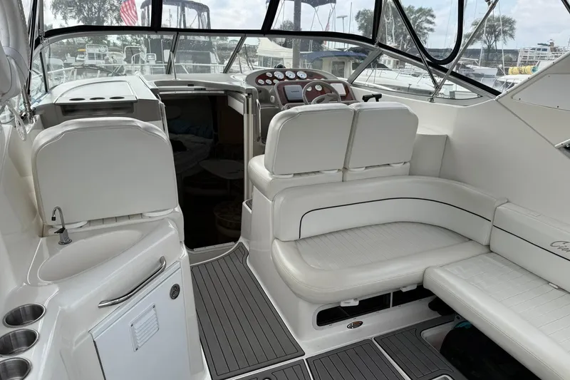 Slide: The Image of 2000 Bayliner 3055 Ciera Sunbridge DX/LX interior with white seating and helm. - 9