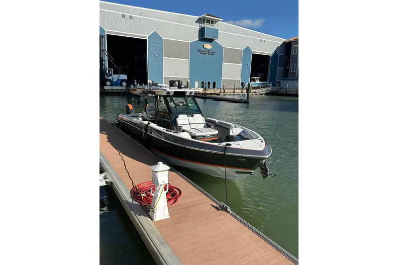 Slide: The Image of 2024 Formula 387 Center Console Fish boat docked at marina, sunny day. - 13