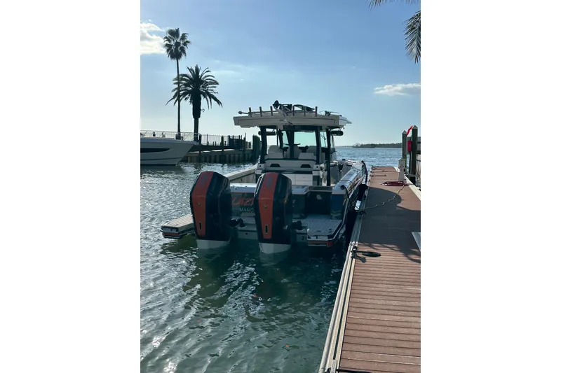 Slide: The Image of 2024 Formula 387 Center Console Fish boat docked by palm trees. - 14