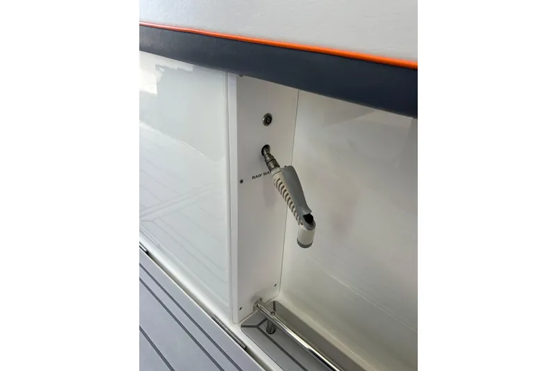 Slide: The Image of 2024 Formula 387 Center Console Fish boat detail with raw water washdown hose. - 35