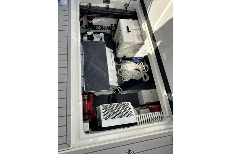 Slide: The Image of 2024 Formula 387 Center Console Fish storage compartment with equipment and rope. - 37