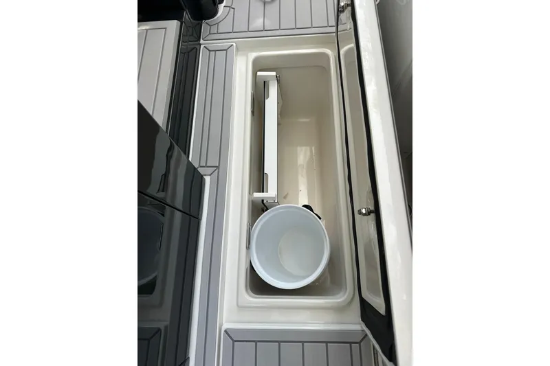 Slide: The Image of 2024 Formula 387 Center Console Fish storage compartment with bucket, open lid view. - 39