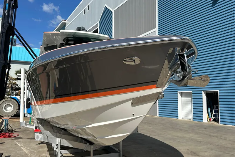 Slide: The Image of 2024 Formula 387 Center Console Fish boat in marina, sleek design with orange accent. - 4