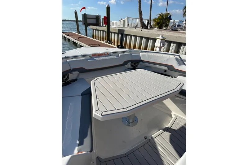 Slide: The Image of 2024 Formula 387 Center Console Fish boat interior with table, docked by the water. - 41