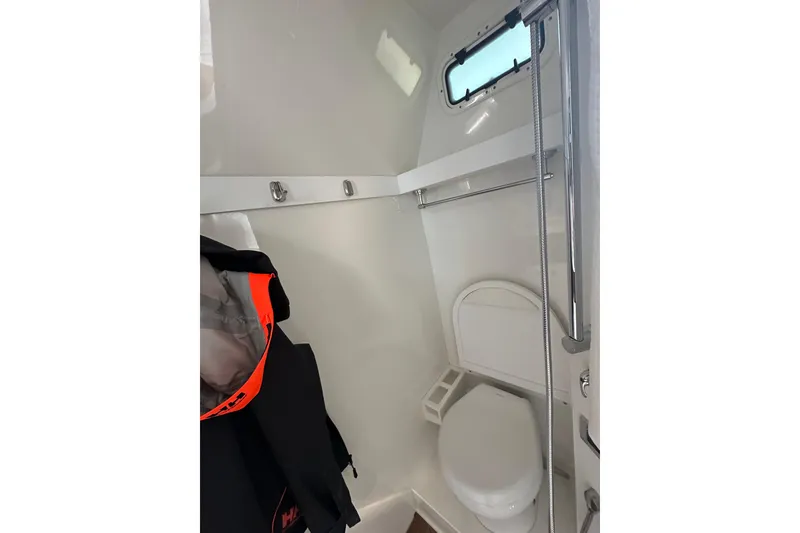 Slide: The Image of 2024 Formula 387 Center Console Fish boat interior bathroom with toilet and window. - 49