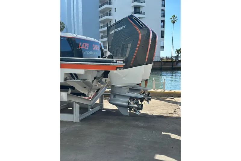 Slide: The Image of 2024 Formula 387 Center Console Fish boat with Mercury outboard engines docked by waterfront. - 7