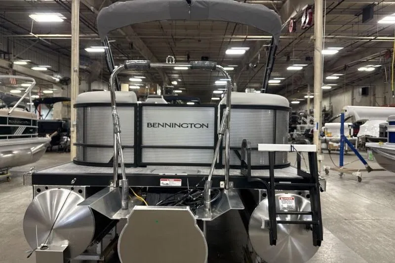 Slide: The Image of 2026 Bennington 22 SSRSF pontoon boat in a warehouse setting. - 4