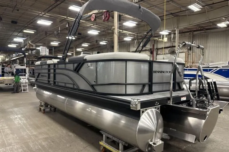Slide: The Image of 2026 Bennington 22 SSRSF pontoon boat in a warehouse setting. - 5