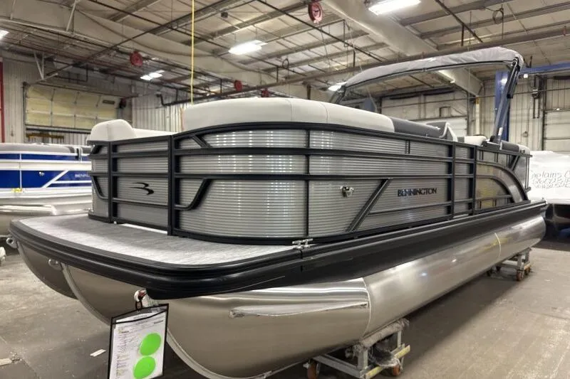 Slide: The Image of 2026 Bennington 22 SSRSF pontoon boat in a showroom, sleek design and modern features. - 6