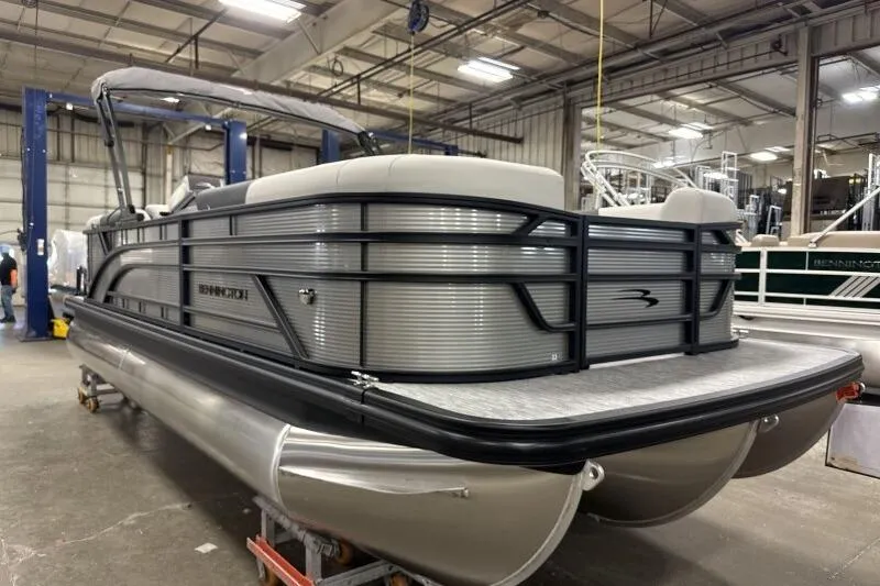 Slide: The Image of 2026 Bennington 22 SSRSF pontoon boat in a warehouse setting. - 8