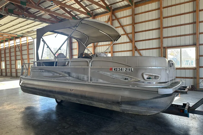 The Image of 2008 Princecraft Vectra 200 L pontoon boat in a spacious indoor storage facility. - 1