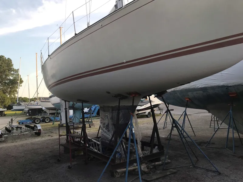 Slide: The Image of 1985 C&C 37 sailboat on stands in a marina. - 17