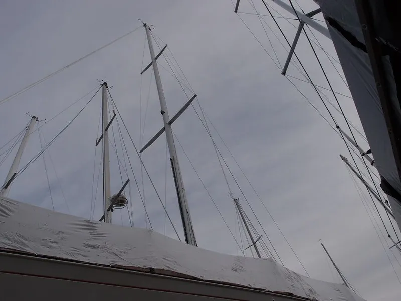 Slide: The Image of Masts of a 1985 C&C 37 sailboat under gray sky. - 18