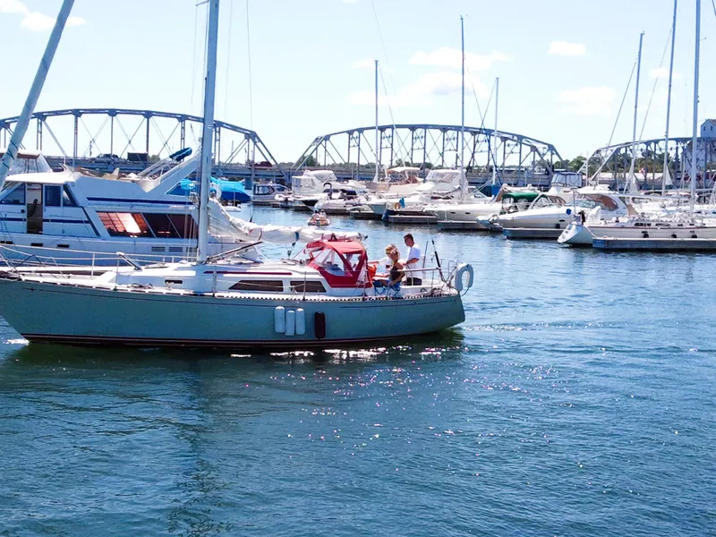 Slide: The Image of 1985 C&C 37 sailboat in harbor with bridge in background. - 3