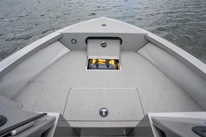 Slide: The Image of Manufacturer Provided Image: 2015 Crestliner 1850 Commander boat bow with storage compartments on water. - 10