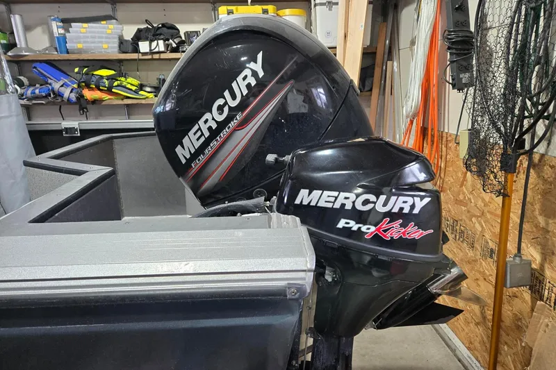 Slide: The Image of 2015 Crestliner 1850 Commander with Mercury outboard motors in a garage setting. - 2