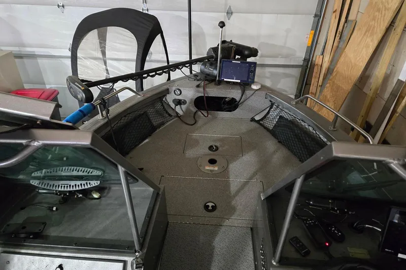 Slide: The Image of 2015 Crestliner 1850 Commander boat interior with fishing equipment and navigation system. - 4