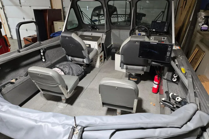 Slide: The Image of 2015 Crestliner 1850 Commander boat interior with seating and navigation equipment. - 5