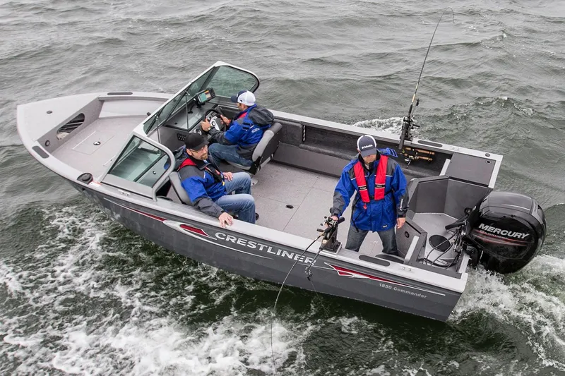 Slide: The Image of Manufacturer Provided Image: 2015 Crestliner 1850 Commander boat with three people fishing on a lake. - 8