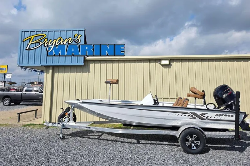 The Image of 2026 Xpress H18 boat at Bryan's Marine dealership under cloudy sky. - 1