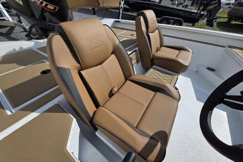 Slide: The Image of 2026 Xpress H18 boat with tan leather seats and modern interior design. - 10