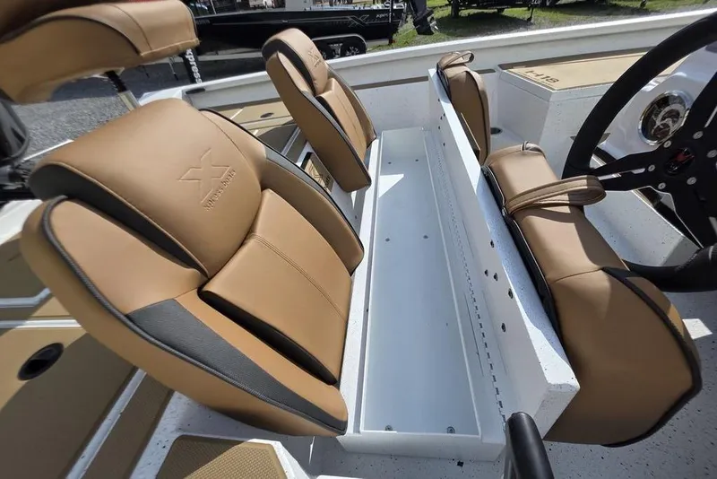 Slide: The Image of 2026 Xpress H18 boat interior with tan seats and steering wheel. - 19