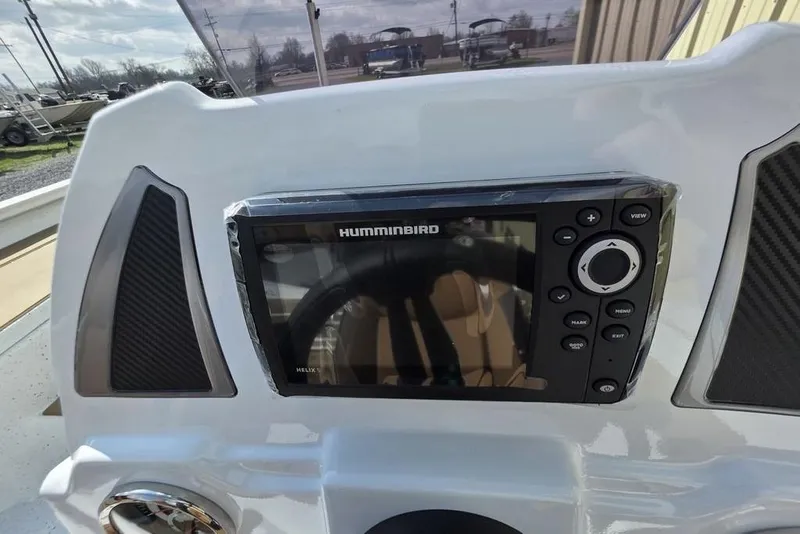 Slide: The Image of Dashboard of 2026 Xpress H18 boat featuring a Humminbird Helix fish finder. - 7