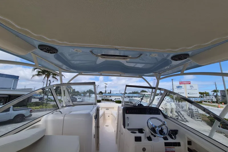 Slide: The Image of 2026 Grady-White Freedom 307 boat interior with helm and seating area. - 11