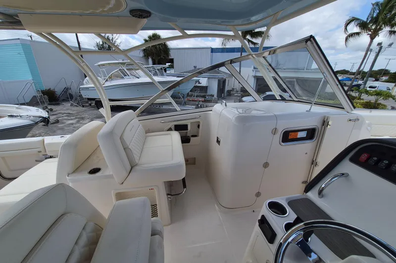 Slide: The Image of 2026 Grady-White Freedom 307 boat interior with seating and helm, showcasing luxury design. - 16