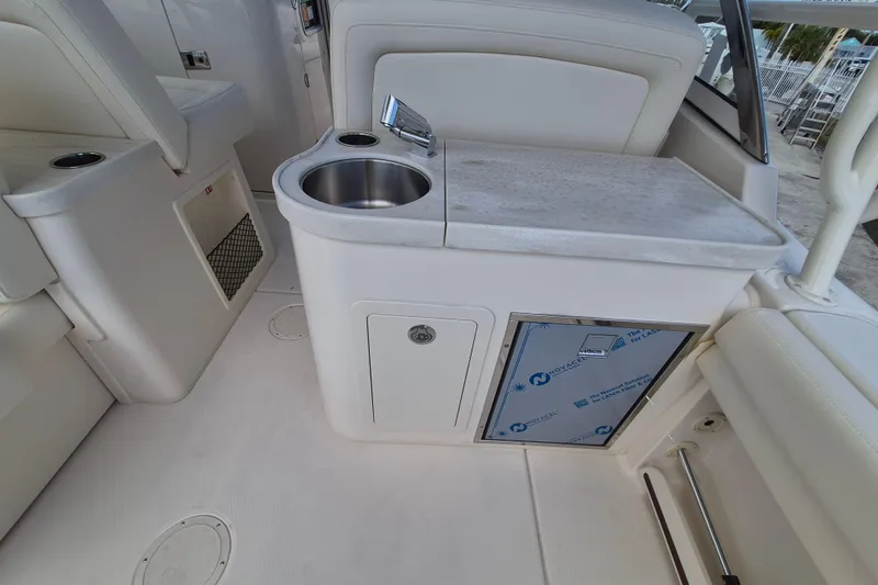 Slide: The Image of 2026 Grady-White Freedom 307 boat interior with sink and storage area. - 19