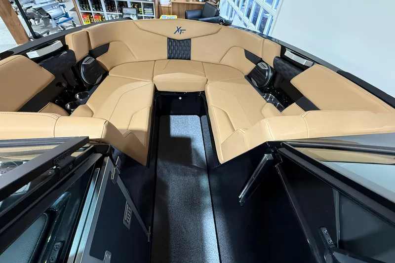 Slide: The Image of 2026 MasterCraft XT24 boat interior with tan seating and modern design. - 2