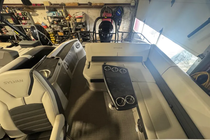 Slide: The Image of 2025 Sylvan G3 CLZ boat interior with seating and table in a workshop setting. - 18