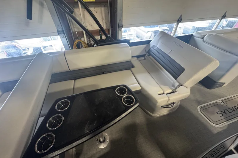 Slide: The Image of Interior of 2025 Sylvan G3 CLZ boat with cushioned seating and cup holders. - 19