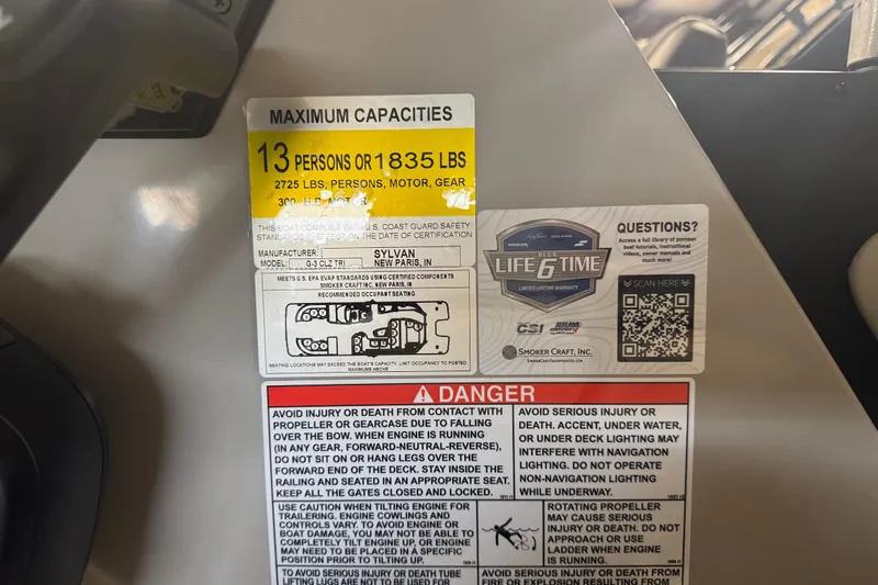 Slide: The Image of Warning labels and capacity information on a 2025 Sylvan G3 CLZ boat. - 27