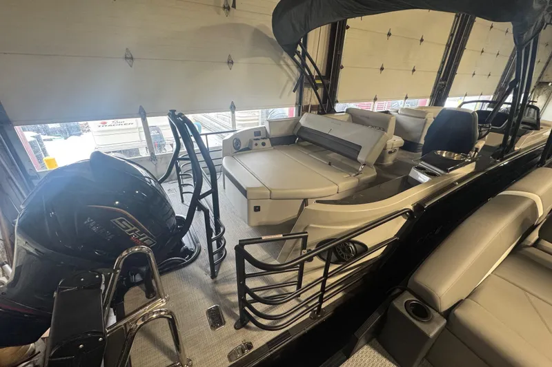 Slide: The Image of 2025 Sylvan G3 CLZ boat interior with seating and outboard motor in a garage. - 34