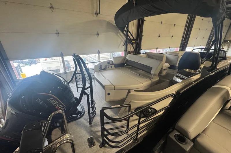 Slide: The Image of 2025 Sylvan G3 CLZ boat interior with seating and Yamaha engine in a garage. - 35