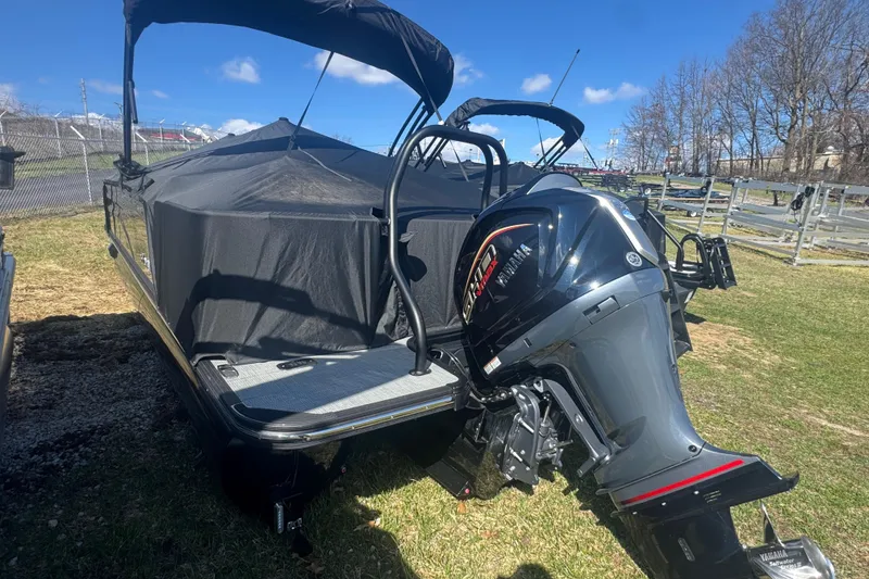 Slide: The Image of 2025 Sylvan G3 CLZ boat with Yamaha outboard motor, covered and parked on grass. - 38